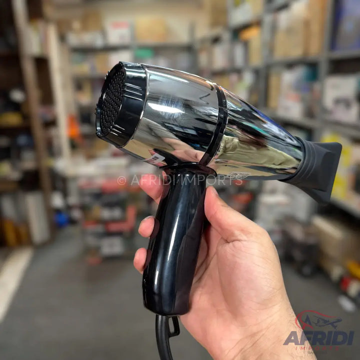 A black and chrome professional hair dryer with a narrow nozzle attachment.