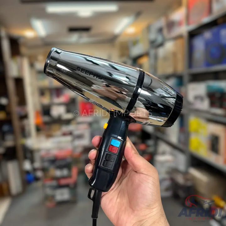 Chrome-plated hair dryer with multiple heat and speed settings.