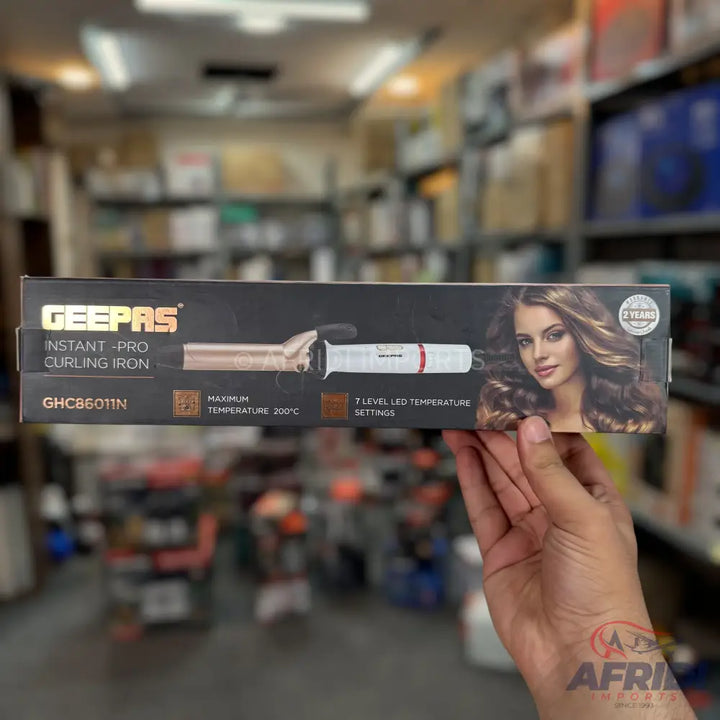 A Geepas Instant-Pro curling iron with 7 LED temperature settings and a maximum temperature of 200°C.