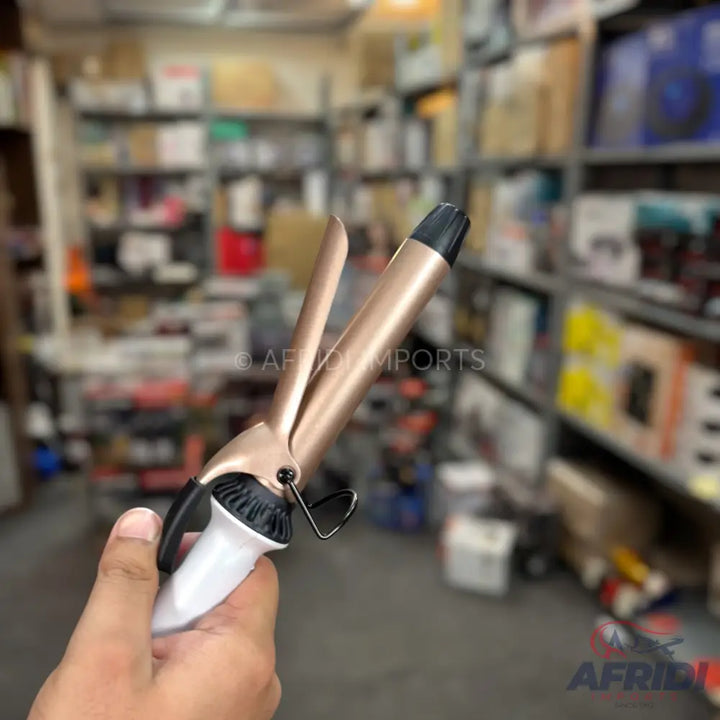 Rose gold and white hair curling iron.
