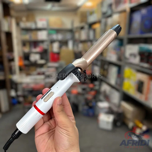 White and gold hair curling iron with a black cord.