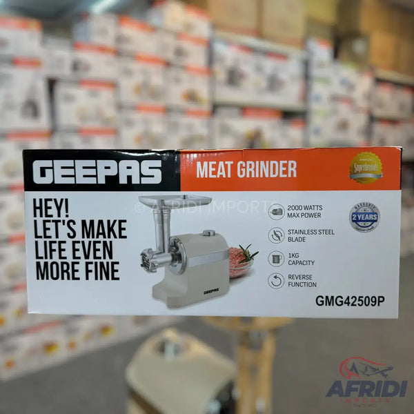 A boxed Geepas meat grinder with 2000 watts max power, stainless steel blade, 1kg capacity, and reverse function, model GMG42509P.