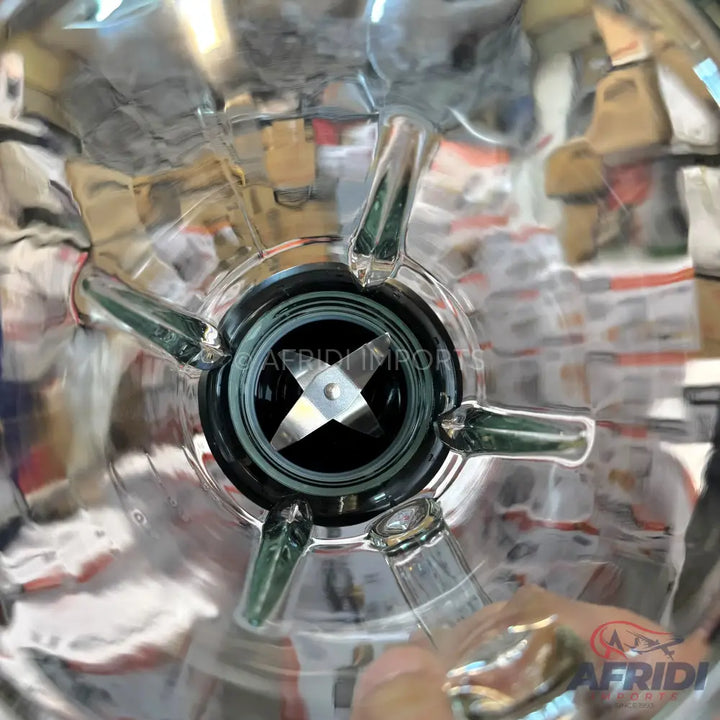A blender with four sharp, stainless steel blades at its base.