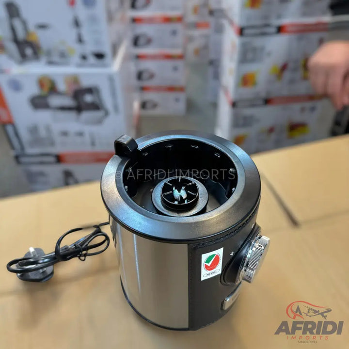 Stainless steel and black countertop food processor with a power cord and control knob.