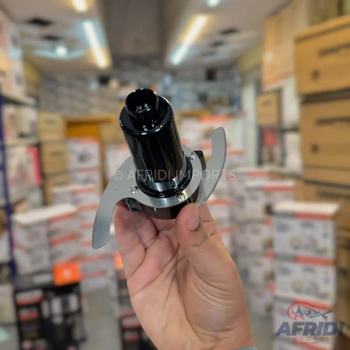 A food processor blade assembly with a black central housing and two silver-colored blades.