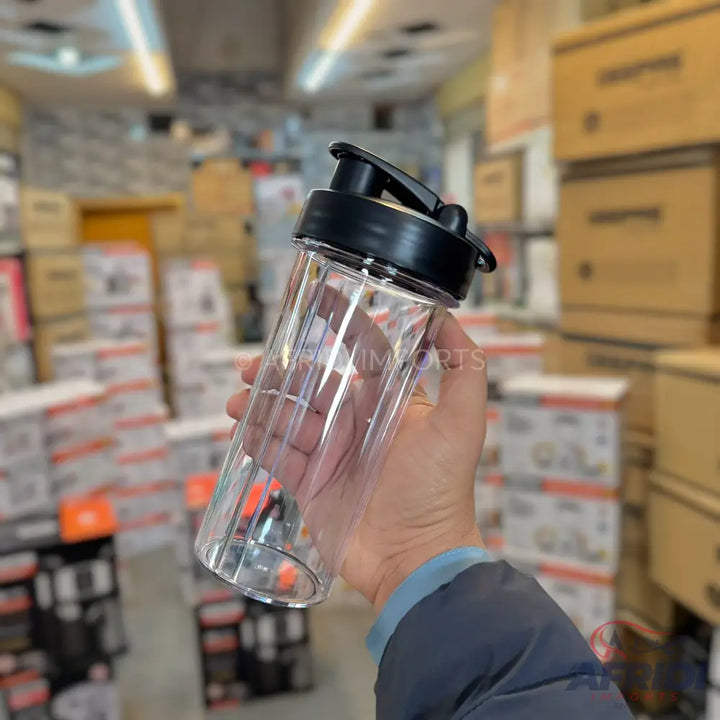 Clear plastic protein shaker bottle with a black lid and handle.