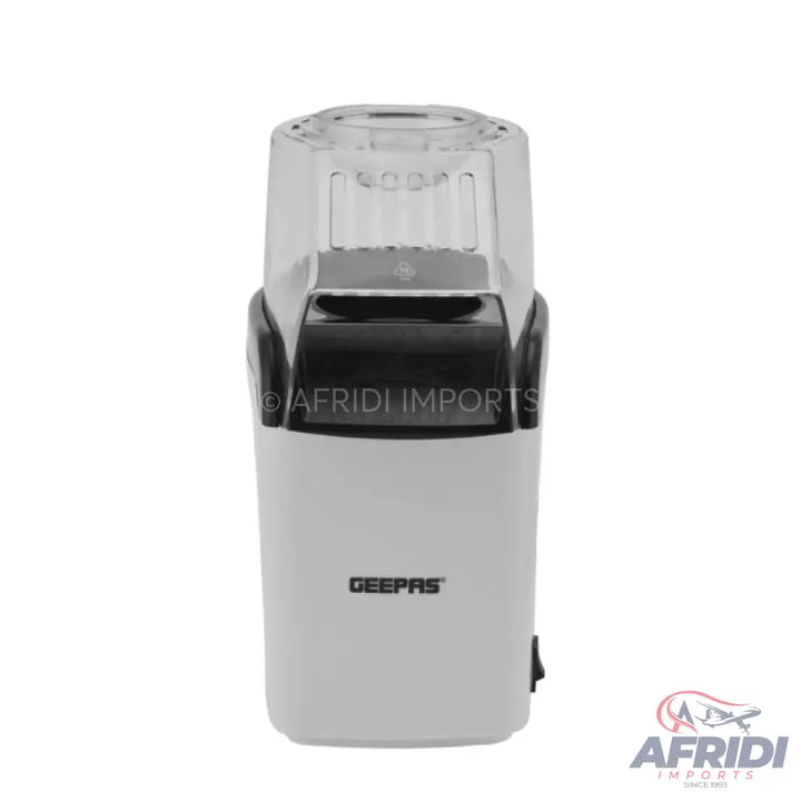 White and black electric spice or coffee grinder with a clear top.