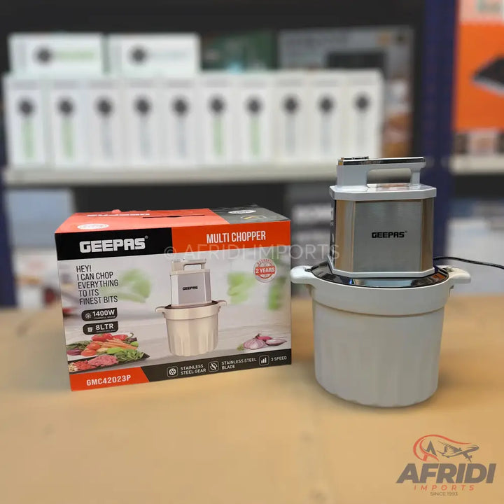 A multi-chopper with a stainless steel top, a white base, and a matching box highlighting its 1400W power and 5-liter capacity.