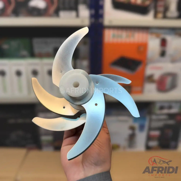 A five-bladed, light-colored plastic fan impeller.