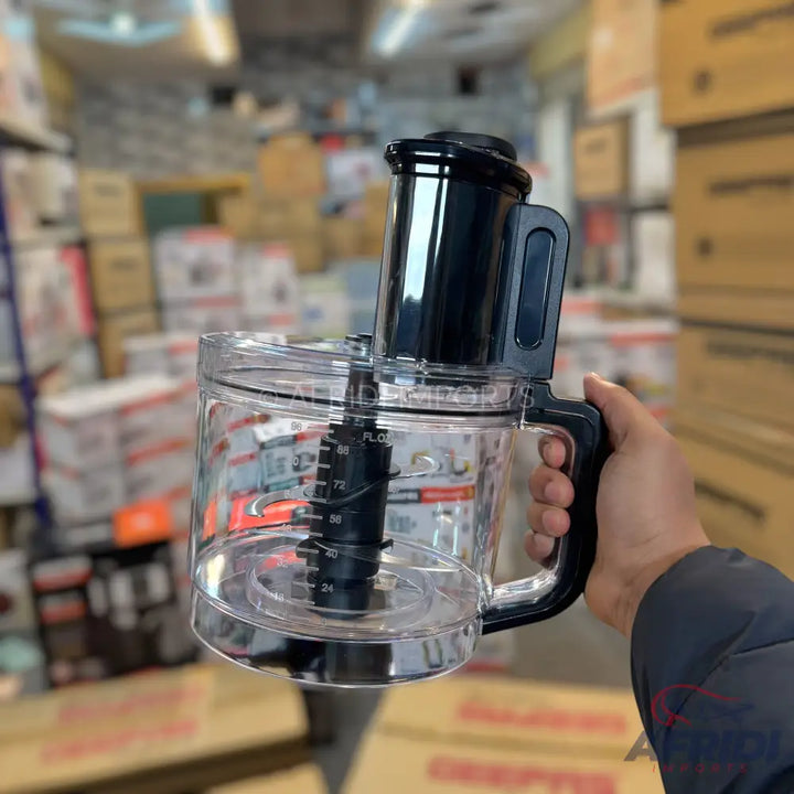 A clear plastic food processor bowl with a black handle and a black central spindle.