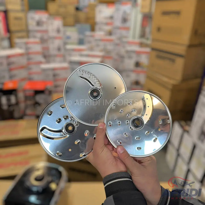 Three stainless steel food processor blades with different cutting patterns.