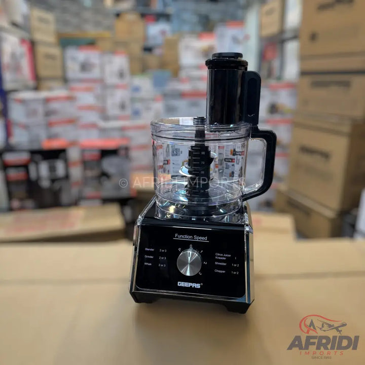 A black and clear food processor with a control dial.