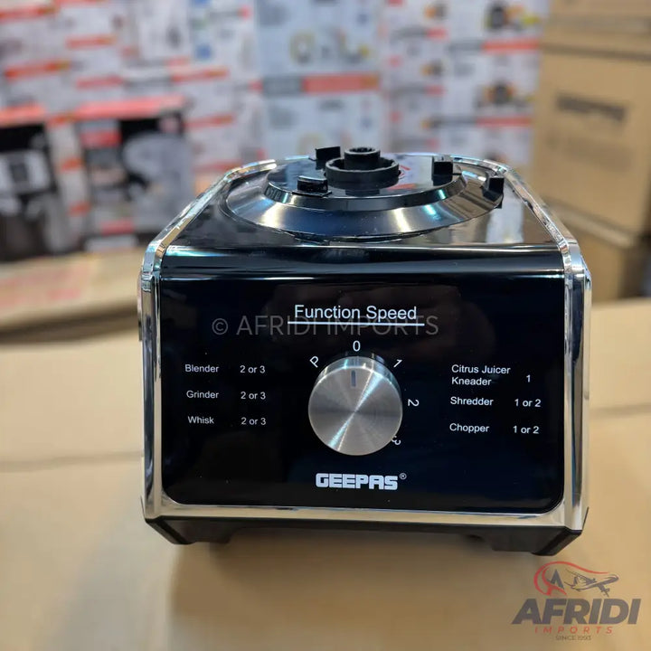A black and silver food processor with a speed dial and various function settings.