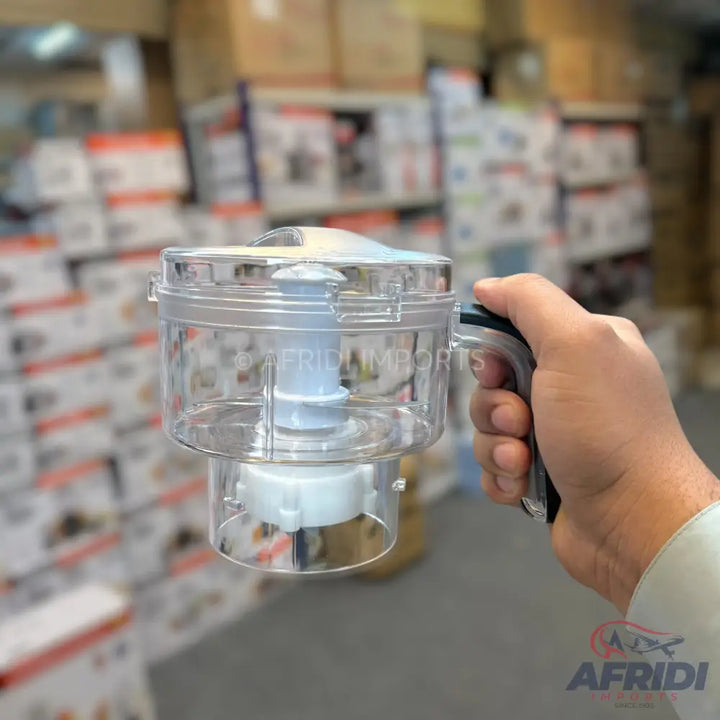 A hand-held, clear plastic food chopper with a pull-cord mechanism.