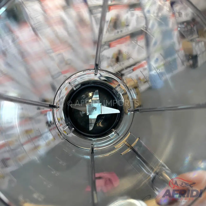 Stainless steel blender jar with a four-pronged blade.