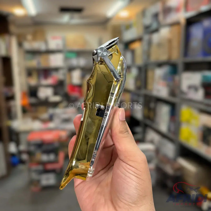 A gold and silver professional hair clipper.