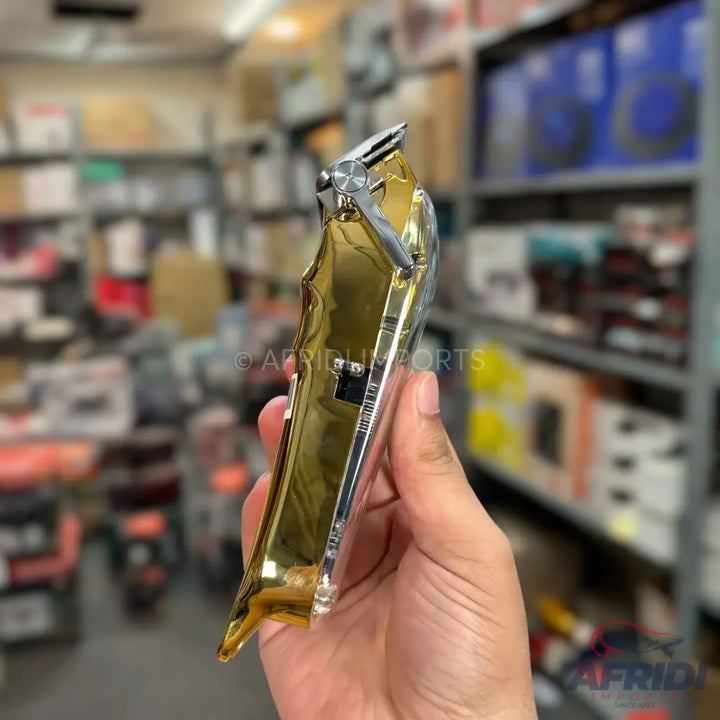 Shiny gold and silver electric hair clipper.