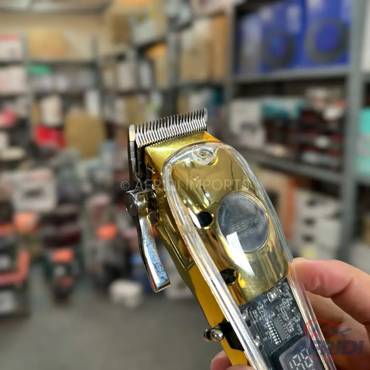 Gold and clear professional hair clipper with a digital display.