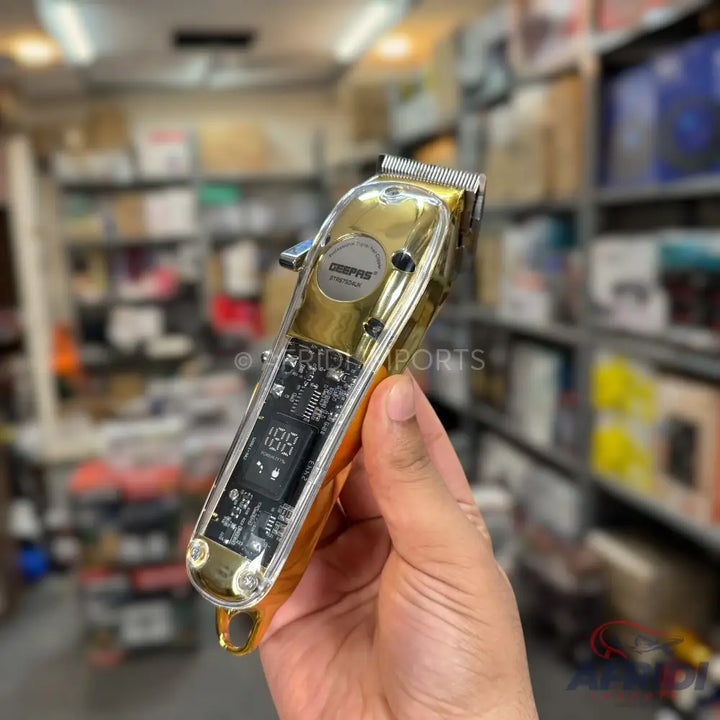 Gold-colored electric hair clipper with a digital display showing ’188’’.