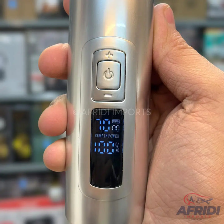 A silver hair clipper with a digital display showing ’7000 RPM’ and ’REMAIN POWER 100%,’ featuring power and adjustment buttons.