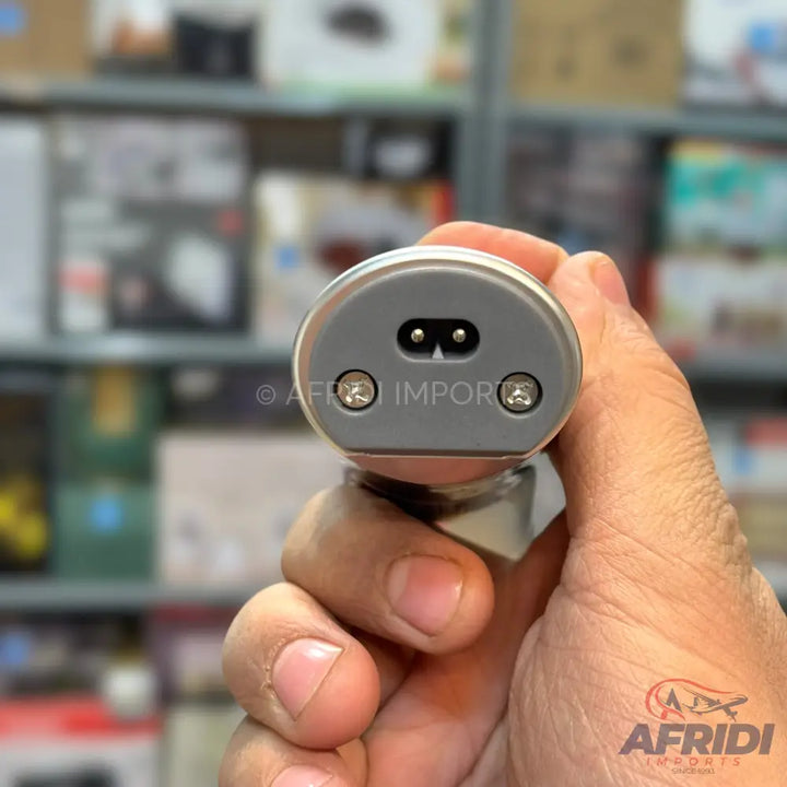 A handled device with a two-prong power inlet and two visible screws on the end.