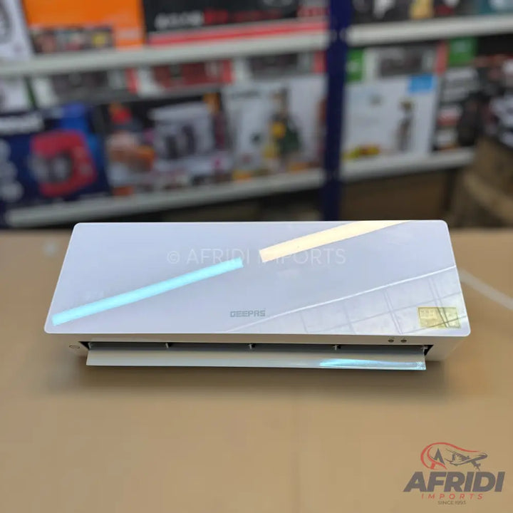 A white, rectangular air conditioner unit with a reflective surface and light-colored accents.