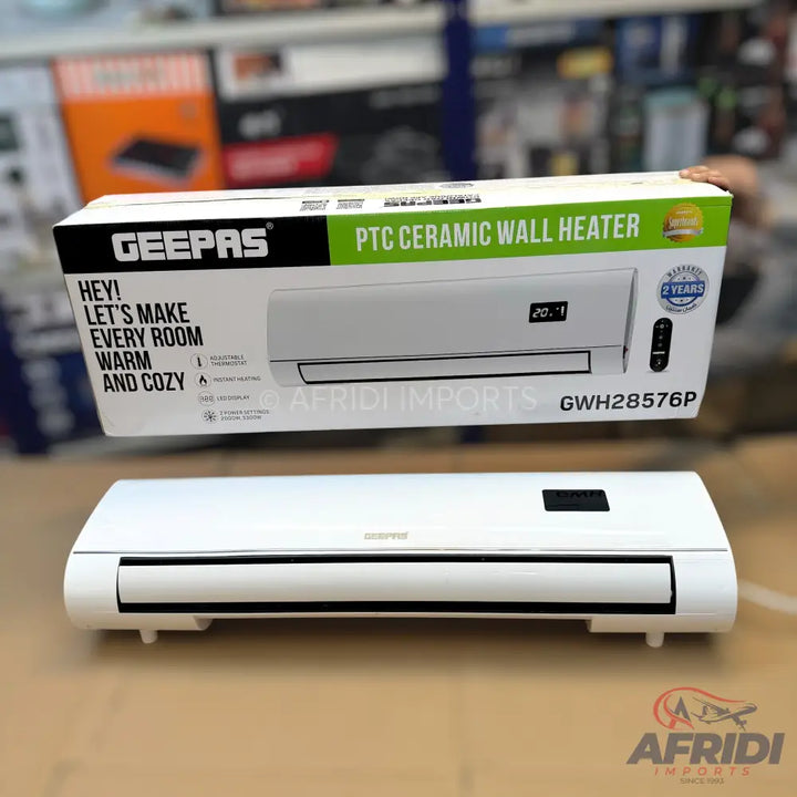 A white Geepas PTC ceramic wall heater with a digital display and remote control.