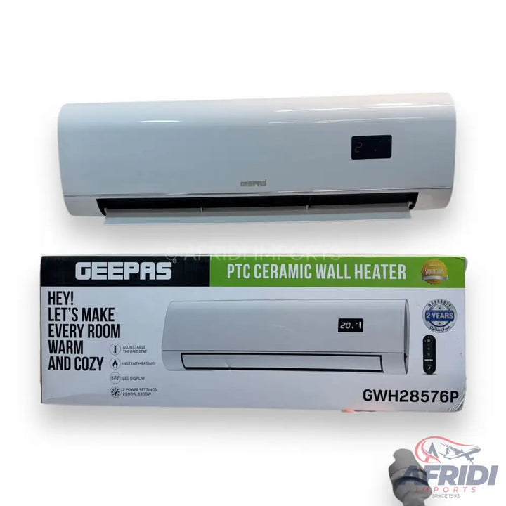 A white wall-mounted ceramic heater with a digital display and a remote control, packaged in a box that highlights its warming capabilities and two-year warranty.
