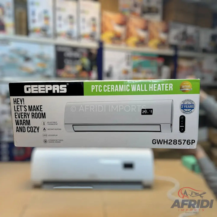 A Geepas PTC ceramic wall heater in its packaging, featuring a white unit with a digital display and remote control, offering two years of warranty.