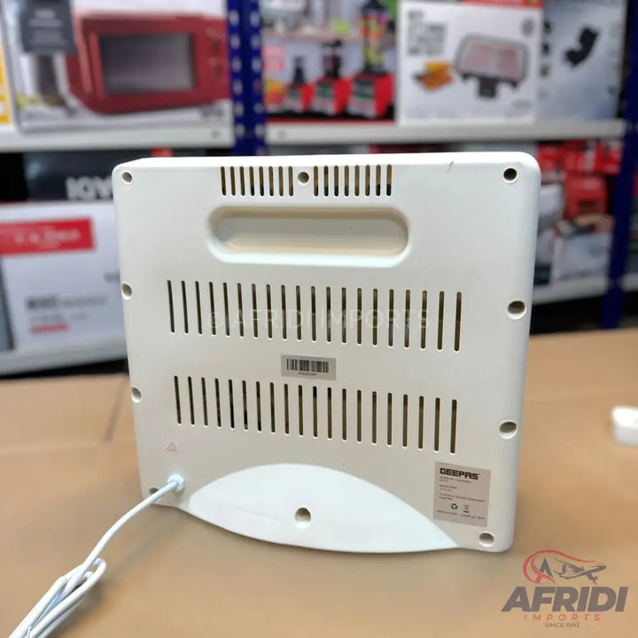 White electric heater with a carrying handle and power cord.