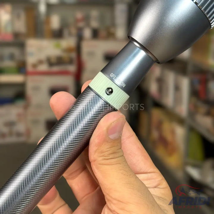 Metallic gray microphone with a textured grip and a light green band near the top.