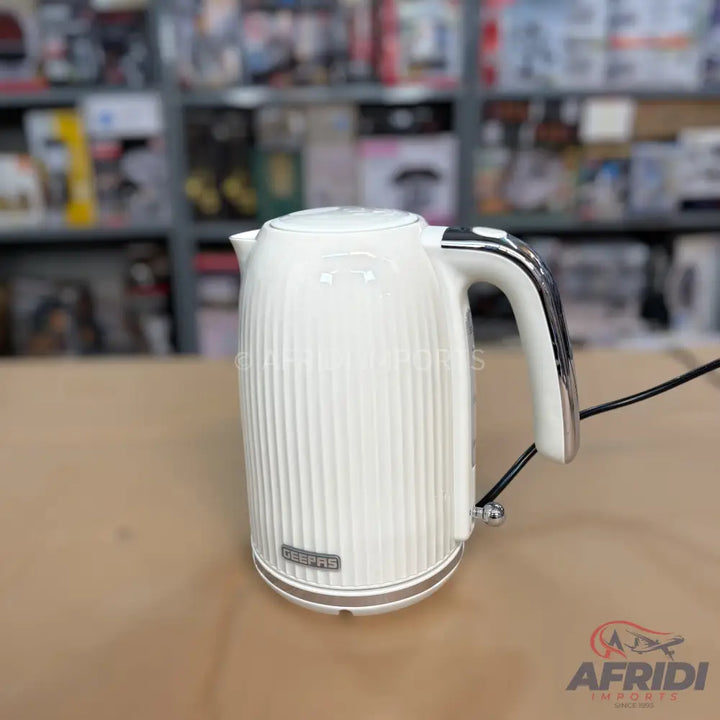 White electric kettle with a ribbed design and chrome handle.