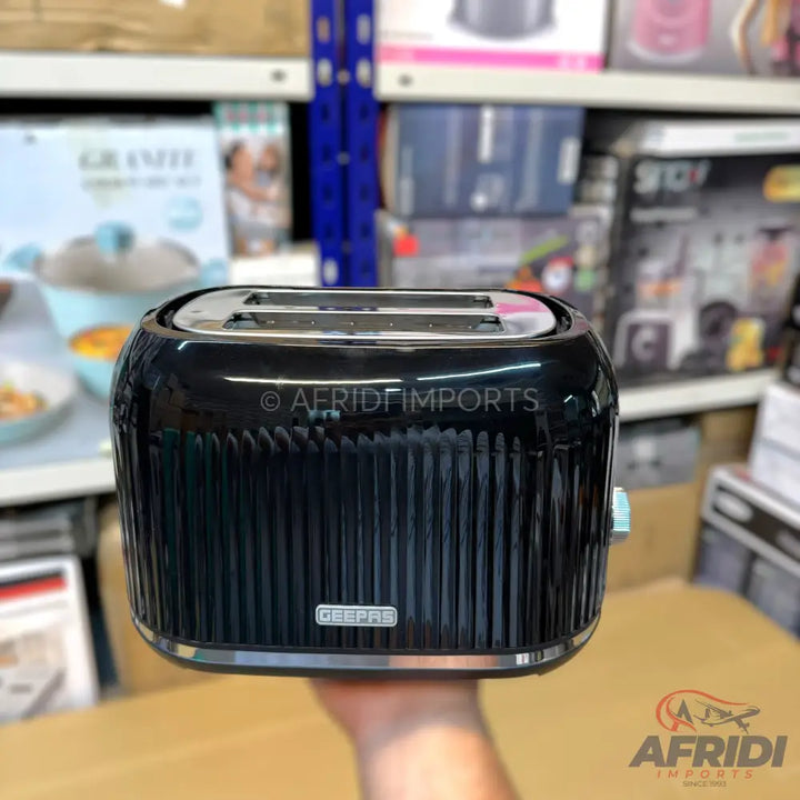 Shiny black two-slice toaster with vertical ridges.