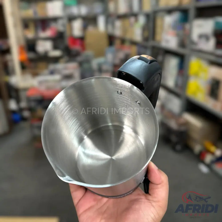 Silver-colored metal melting pot with a black handle and pour spout.