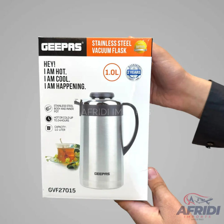 A silver stainless steel vacuum flask with a black handle and top, displayed in its product packaging.