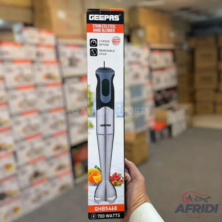 A Geepas stainless steel hand blender with two speeds and a removable stick, featuring a 700-watt motor.