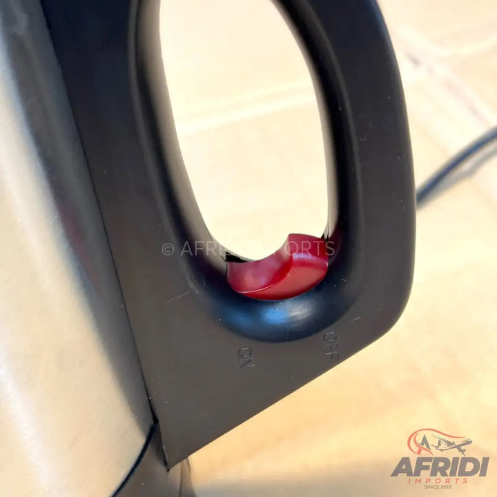 Black electric kettle with a red power switch.