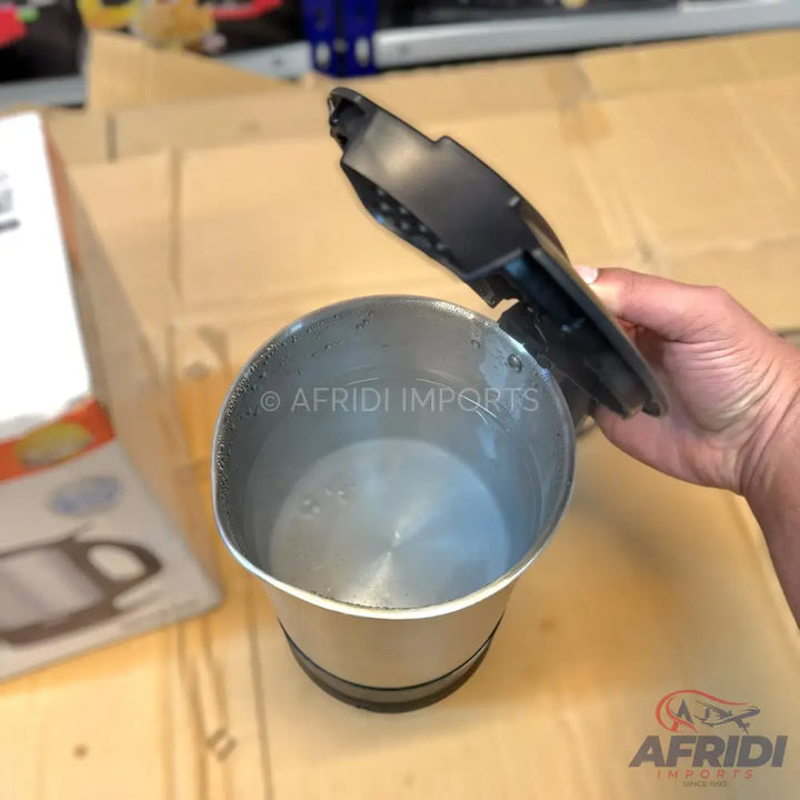 A silver electric kettle with an open black lid.