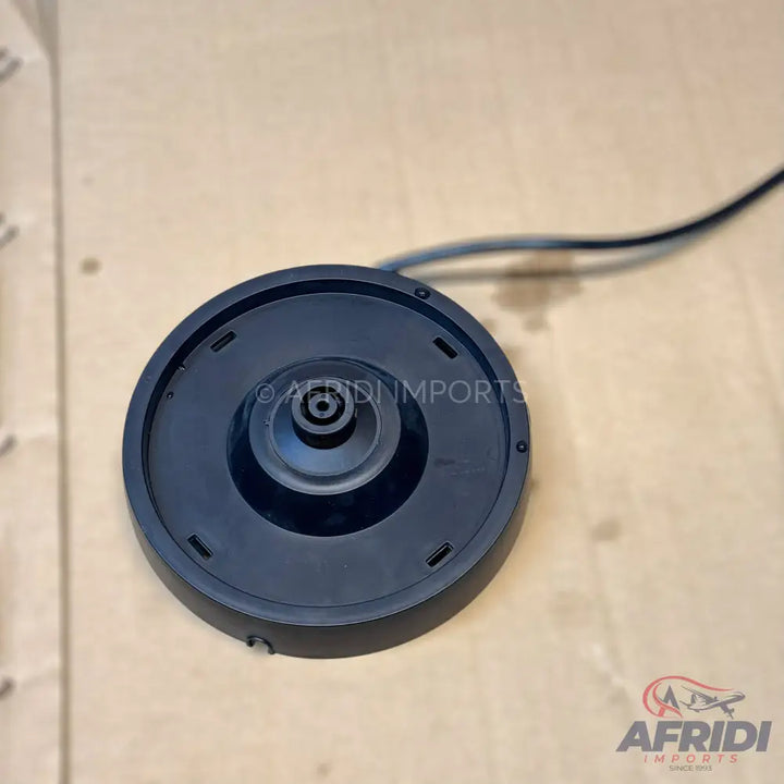 Black electric kettle base with a central heating element connector and attached power cord.