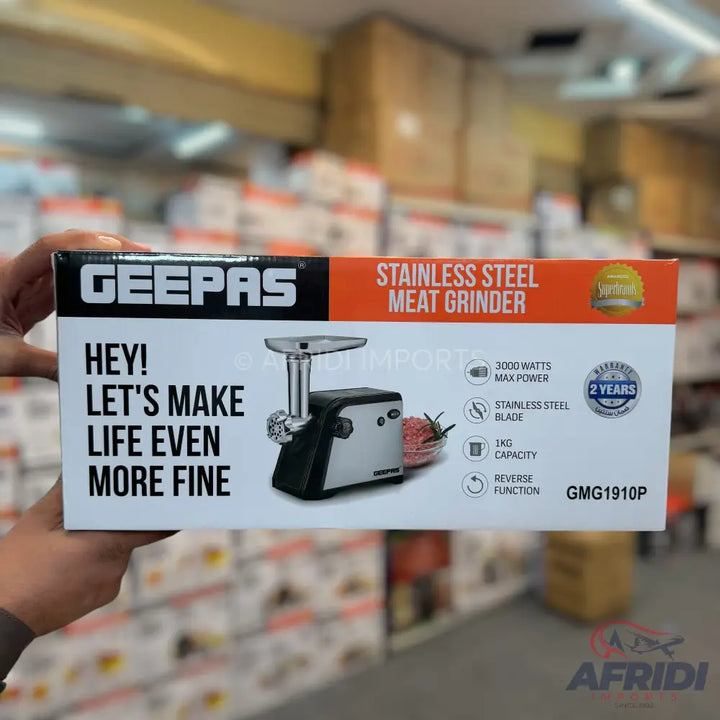 Geepas stainless steel meat grinder with 3000 watts max power, 1kg capacity, and reverse function, offering a 2-year warranty.