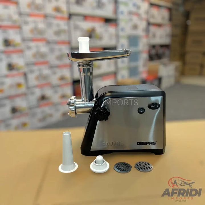 A silver and black electric meat grinder with various attachments for different grinding needs.