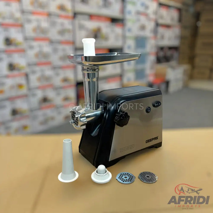A silver and black electric meat grinder with various attachments for different grinding options.