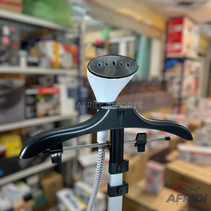 White and black upright garment steamer with a hanger attachment.