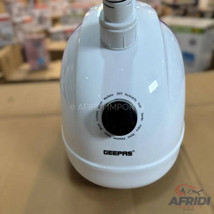 White garment steamer with a fabric type selector dial.