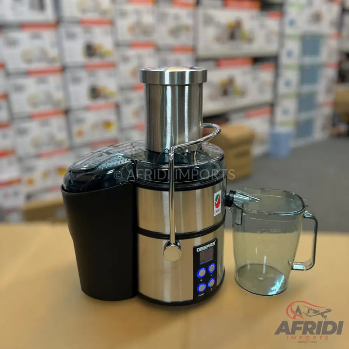 A stainless steel juicer with a black pulp container and a clear juice pitcher.