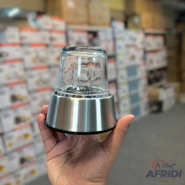 A compact, stainless steel and glass blender with a single-serve cup.