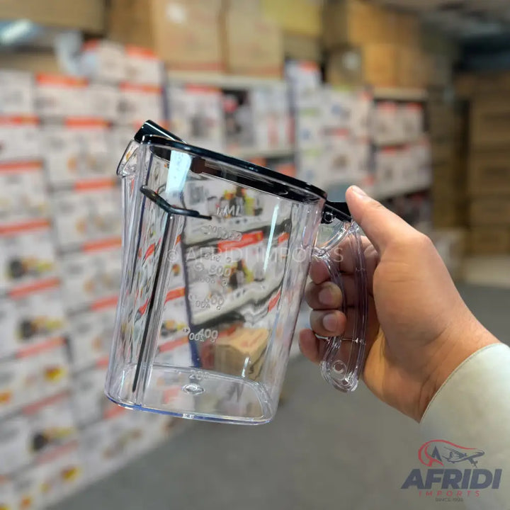 A clear plastic measuring cup with a black rim and handle.