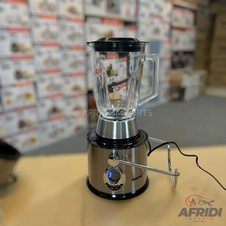 A stainless steel blender with a glass jar and digital display.