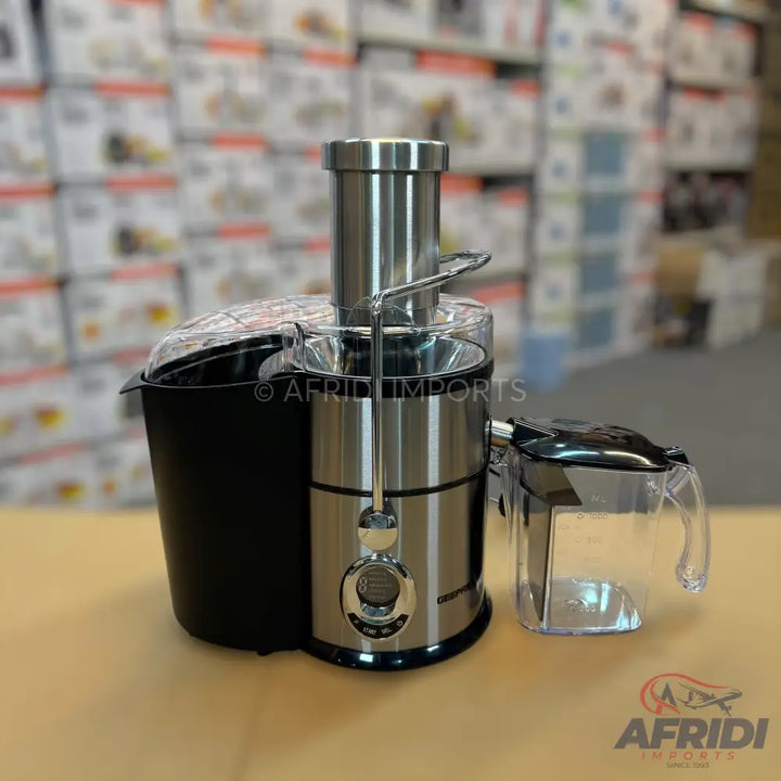 Stainless steel and black centrifugal juicer with a clear pulp container and juice pitcher.