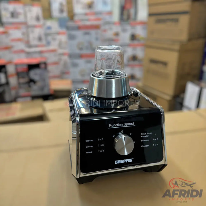 A black and silver multi-function food processor with a speed dial and various processing options.